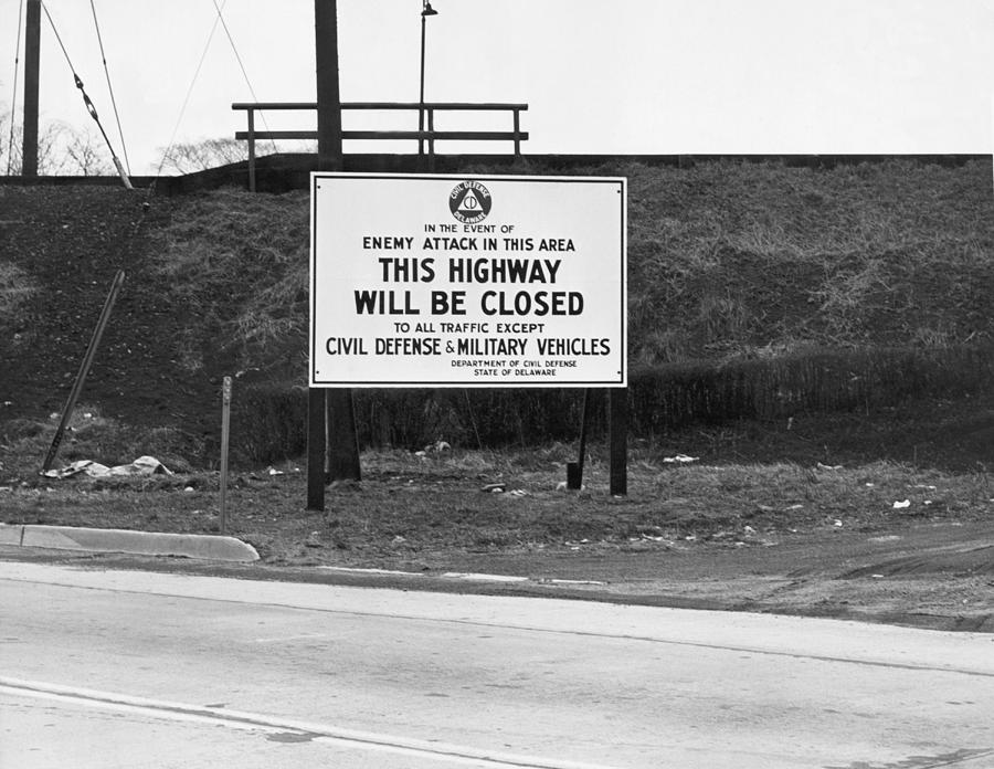 Highway sign stating the highway will be closed in the event of enemy attack in the area, from the Department of Civil Defence, State of Delaware.
