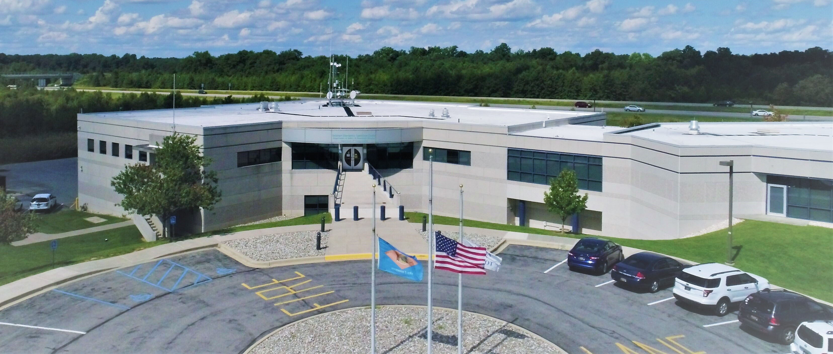 A view looking down at the DEMA building in Smyrna, Delaware from a drone in the parking lot.