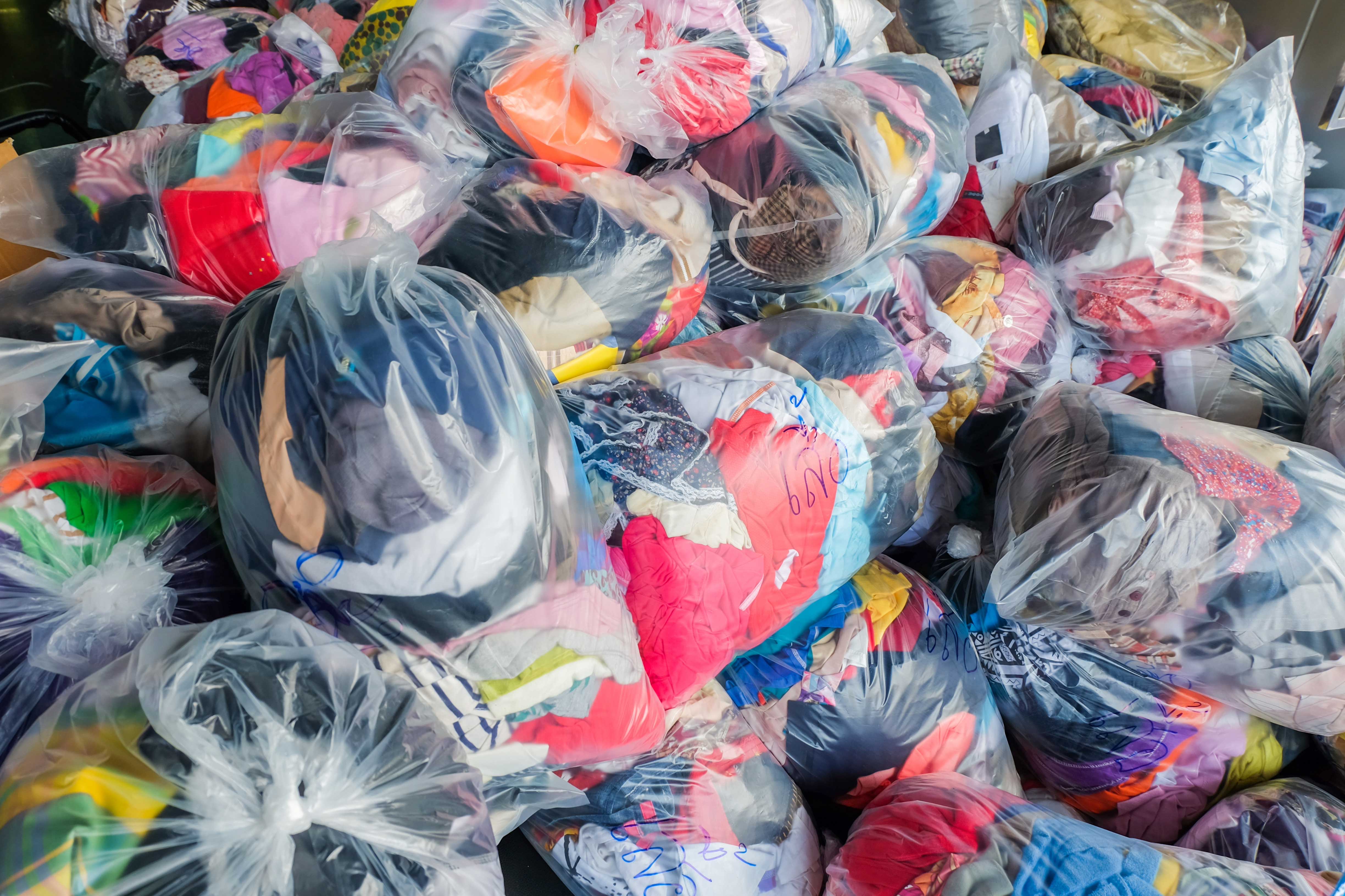 Image showing a pile of donated items in clear plastic bags